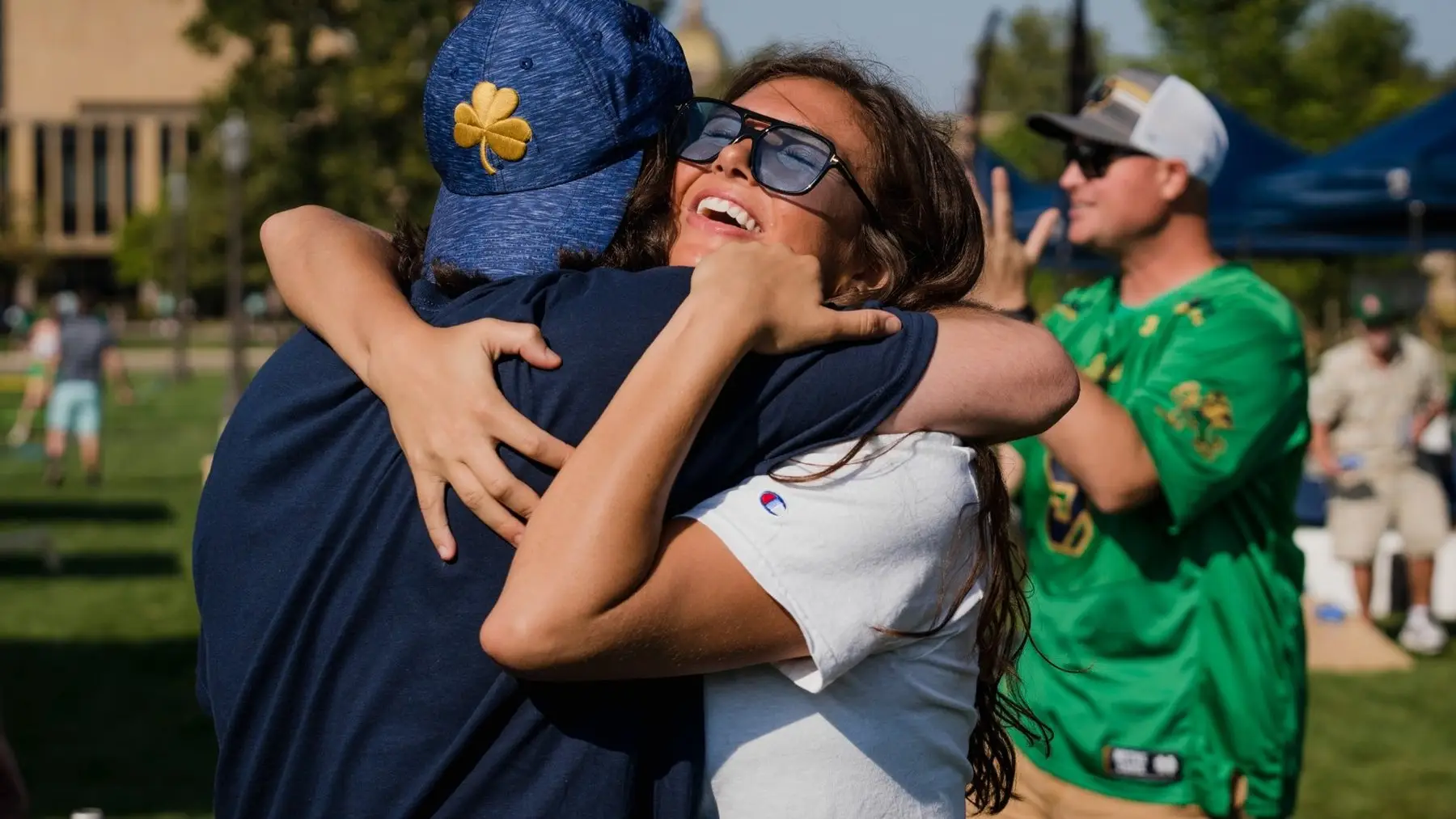 Notre Dame fans hugging at a Gameday Your Way tailgate